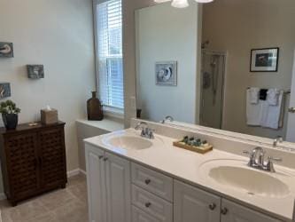 bathroom featuring vanity, an inviting chandelier, and a shower with door