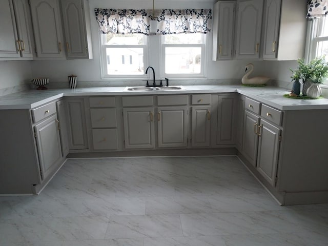 kitchen featuring sink and gray cabinetry