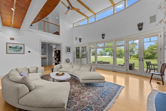 5457 Bayford Rd, Eastville, VA 23354 - living area featuring french doors, ceiling fan, a high ceiling, wood finished floors, and plenty of natural light