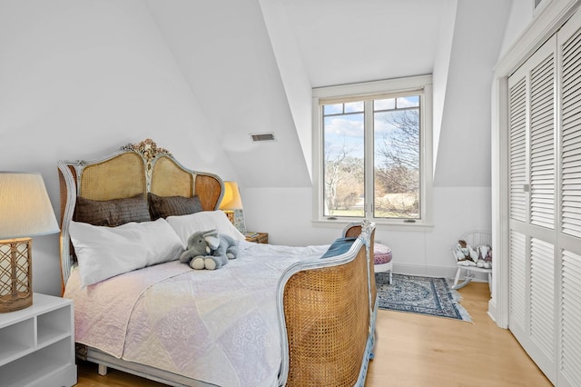 5457 Bayford Rd, Eastville, VA 23354 - bedroom with wood finished floors, a closet, vaulted ceiling, and baseboards