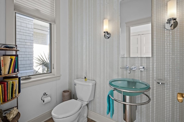 5457 Bayford Rd, Eastville, VA 23354 - bathroom featuring toilet, a sink, and baseboards