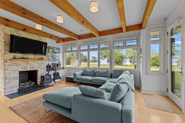 5457 Bayford Rd, Eastville, VA 23354 - living area featuring beam ceiling, wood finished floors, a fireplace, and baseboards