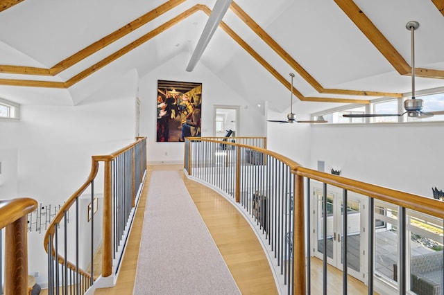 5457 Bayford Rd, Eastville, VA 23354 - corridor featuring beam ceiling, an upstairs landing, high vaulted ceiling, and wood finished floors