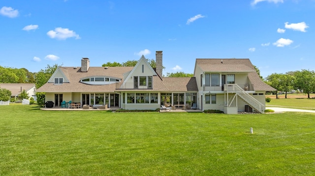 5457 Bayford Rd, Eastville, VA 23354 - back of house with a yard, stairs, a sunroom, a patio area, and a chimney