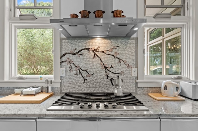 5457 Bayford Rd, Eastville, VA 23354 - kitchen view of stainless steel gas stovetop, white cabinetry, light stone countertops, and tasteful backsplash