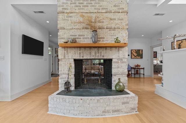 5457 Bayford Rd, Eastville, VA 23354 - detailed view of wood finished floors, a brick fireplace, baseboards, and recessed lighting