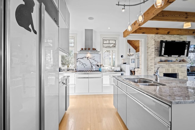5457 Bayford Rd, Eastville, VA 23354 - kitchen with a sink, a fireplace, modern cabinets, stainless steel gas stovetop, and light wood-style flooring