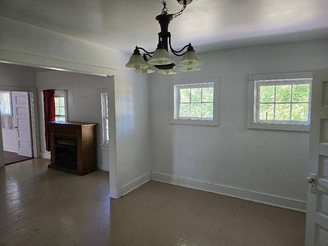 unfurnished dining area with an inviting chandelier