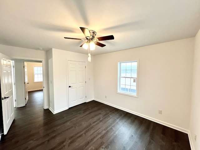 unfurnished bedroom with dark wood-type flooring and ceiling fan