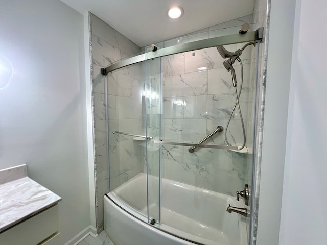 bathroom featuring vanity and combined bath / shower with glass door