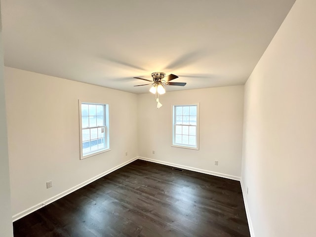 unfurnished room with dark hardwood / wood-style floors and ceiling fan