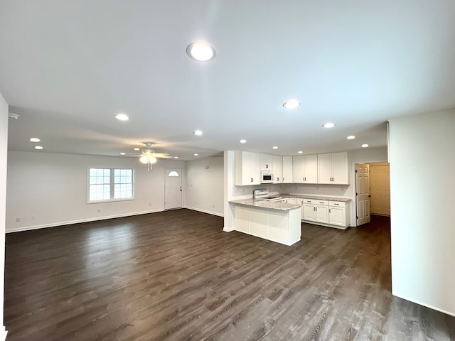 kitchen with white appliances, dark wood-type flooring, ceiling fan, white cabinetry, and kitchen peninsula