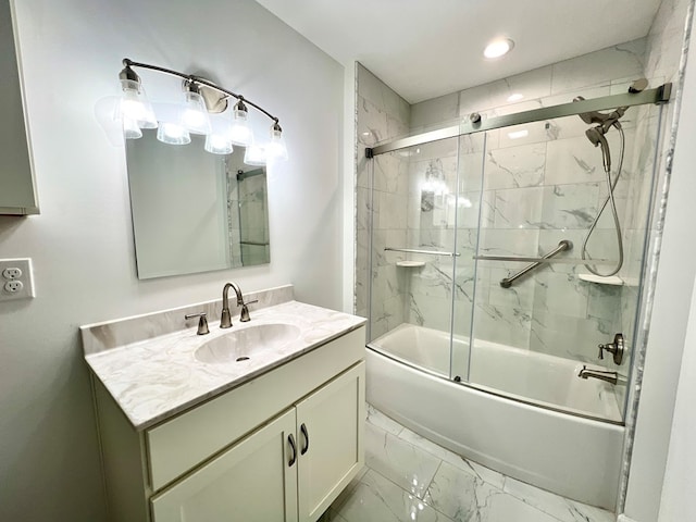 bathroom featuring enclosed tub / shower combo and vanity