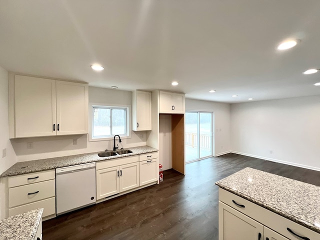 kitchen featuring sink, dishwasher, light stone counters, white cabinets, and dark hardwood / wood-style flooring