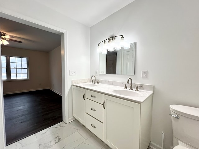 bathroom featuring vanity, ceiling fan, and toilet