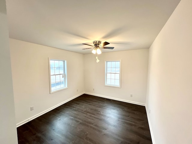 unfurnished room with dark wood-type flooring and ceiling fan