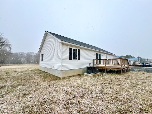 back of property featuring cooling unit and a deck