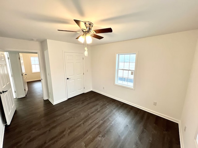 unfurnished bedroom with dark hardwood / wood-style flooring and ceiling fan