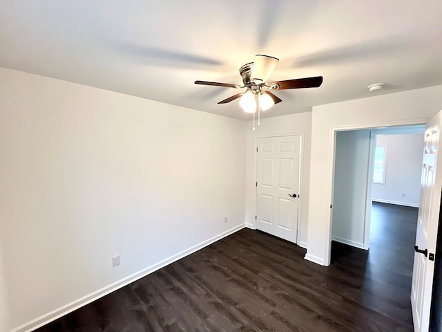 unfurnished bedroom with ceiling fan and dark hardwood / wood-style floors