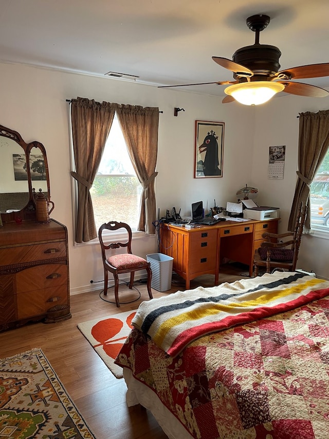 bedroom with ceiling fan and light wood-type flooring