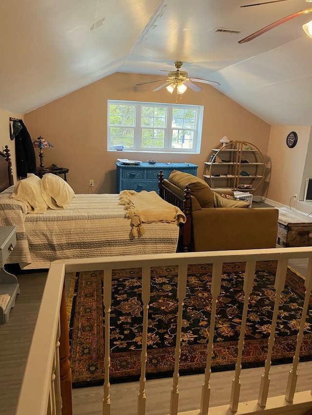 bedroom with ceiling fan, light hardwood / wood-style flooring, and vaulted ceiling