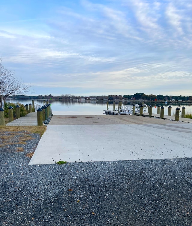 exterior space featuring a boat dock and a water view