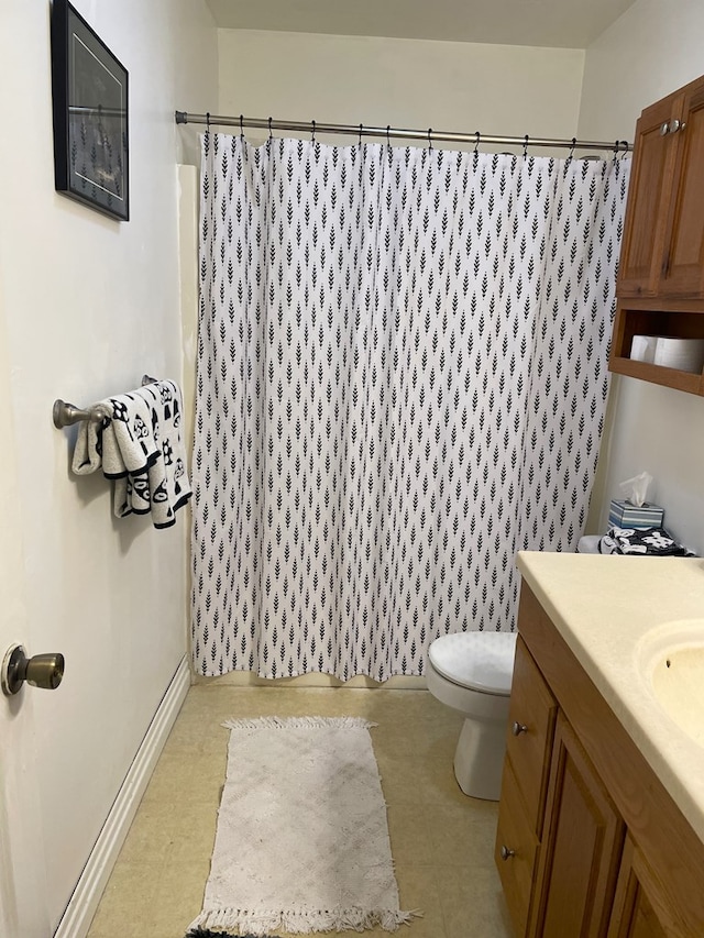 bathroom with vanity, toilet, and walk in shower