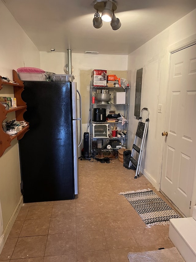 kitchen featuring black refrigerator and electric panel