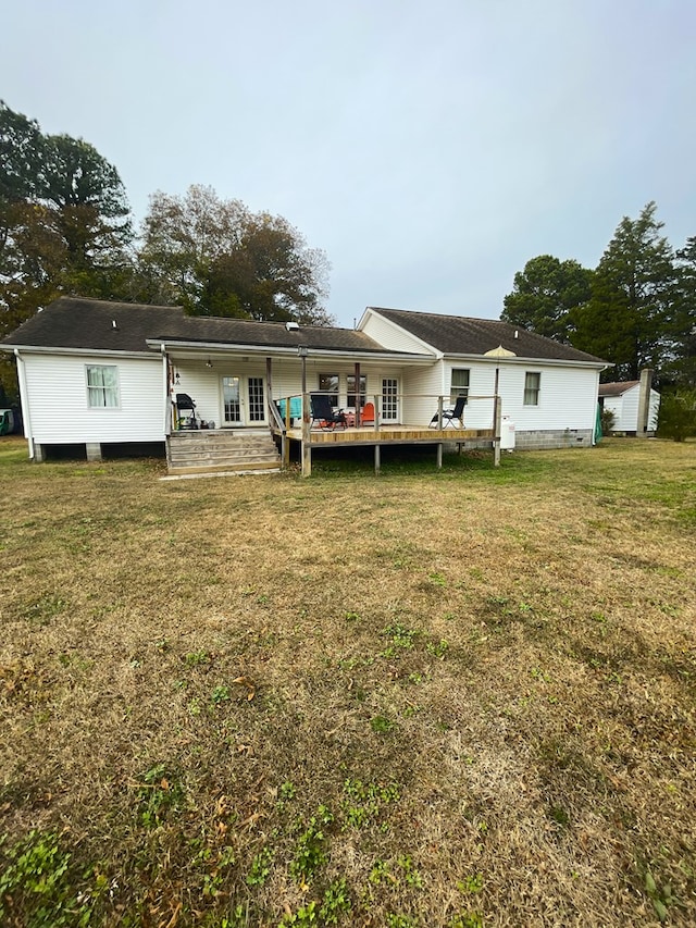 rear view of property with a lawn and french doors