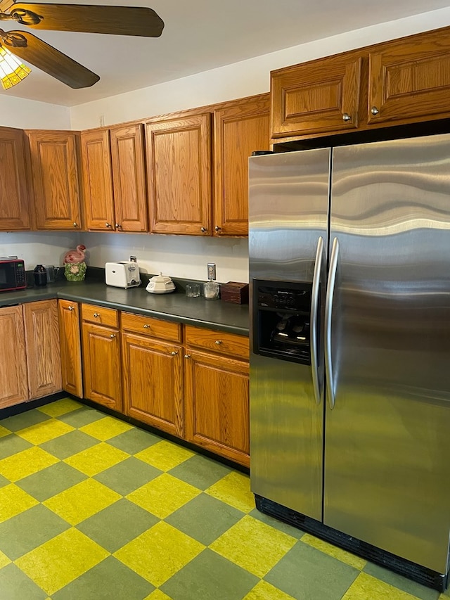 kitchen featuring ceiling fan and stainless steel refrigerator with ice dispenser