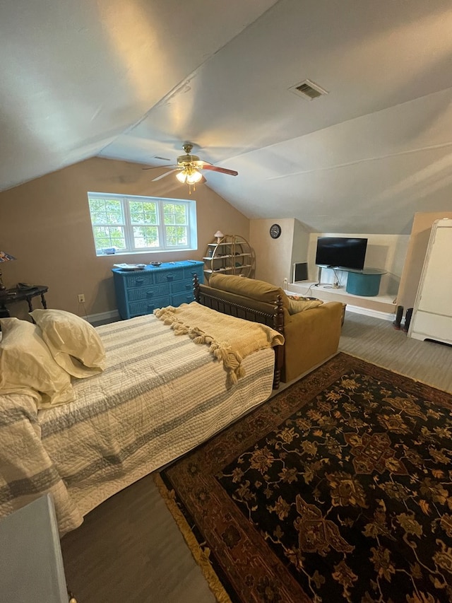 bedroom featuring hardwood / wood-style flooring, ceiling fan, and lofted ceiling