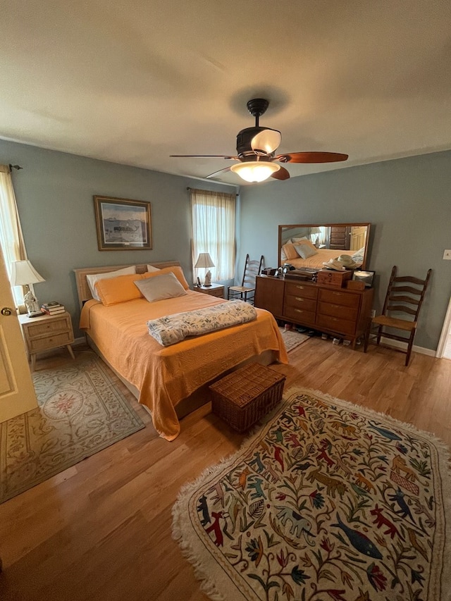 bedroom with ceiling fan and light hardwood / wood-style flooring