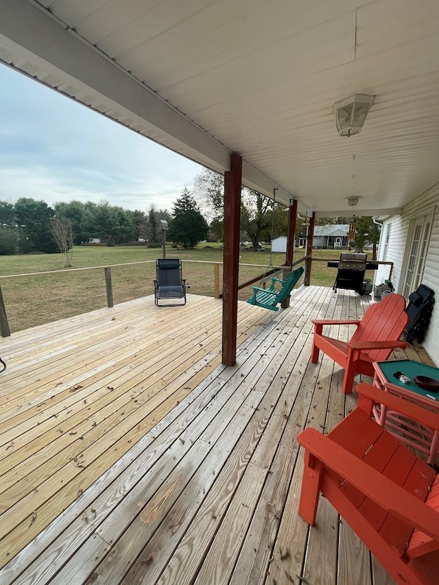 wooden terrace featuring a grill