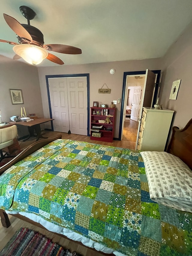 bedroom with ceiling fan, wood-type flooring, and a closet