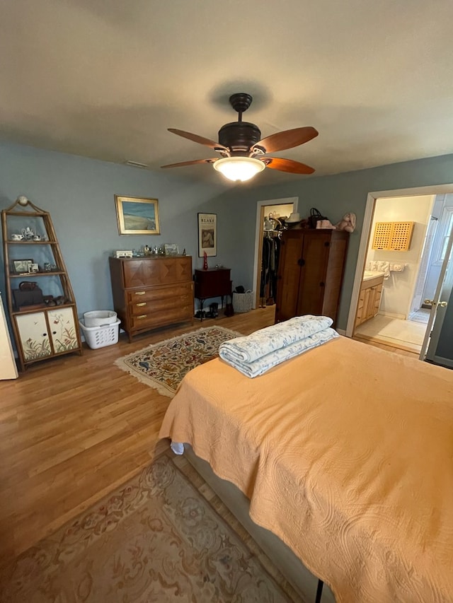 bedroom featuring a spacious closet, ceiling fan, ensuite bathroom, light hardwood / wood-style floors, and a closet