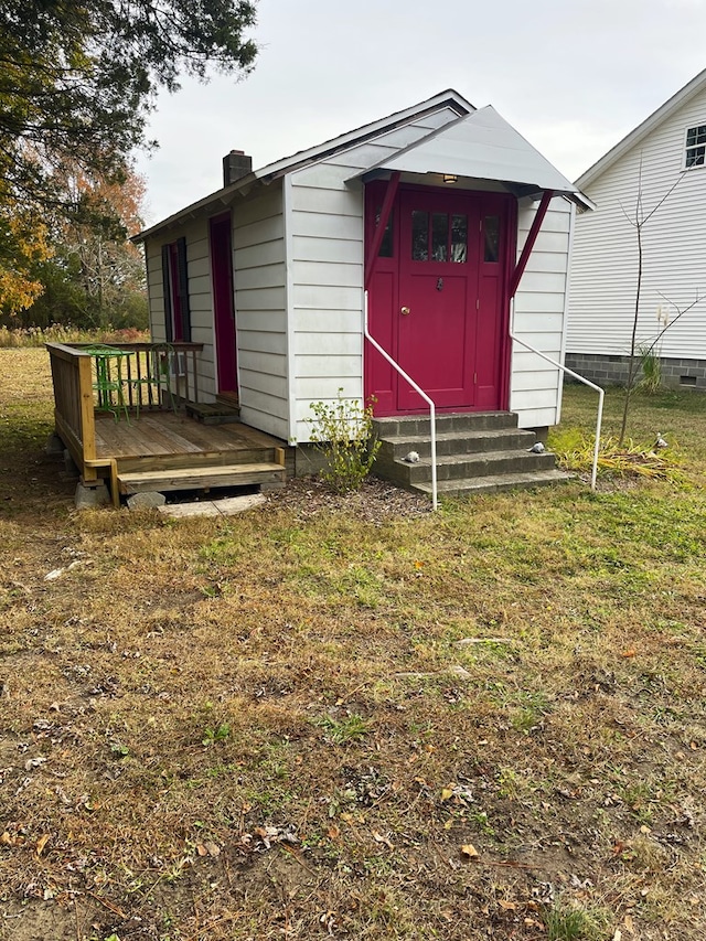 view of outbuilding with a lawn