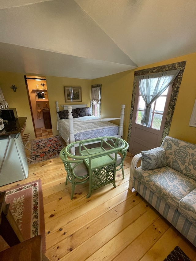 bedroom with wood-type flooring and lofted ceiling