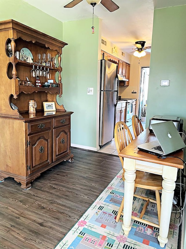 dining space with dark hardwood / wood-style flooring