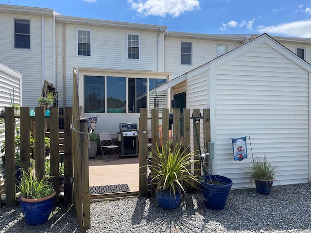 back of property featuring a wooden deck