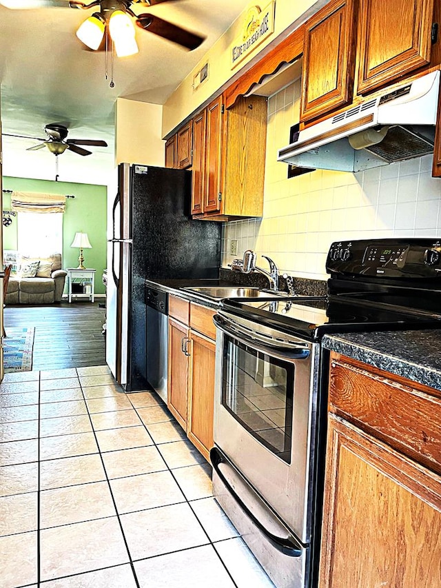 kitchen with sink, stainless steel dishwasher, range with electric stovetop, backsplash, and light tile patterned floors