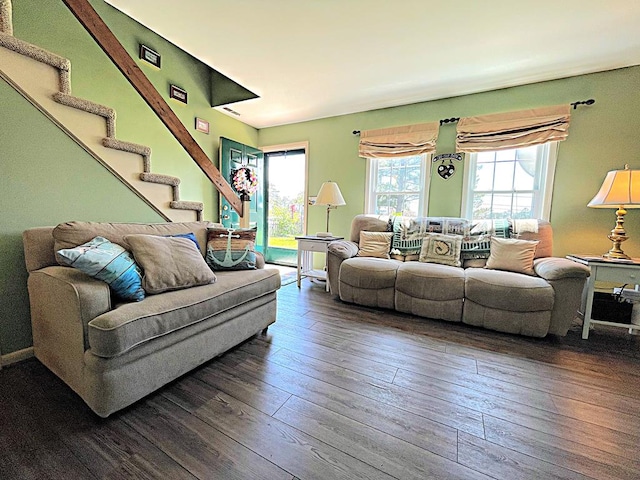 living room featuring a healthy amount of sunlight and dark wood-type flooring