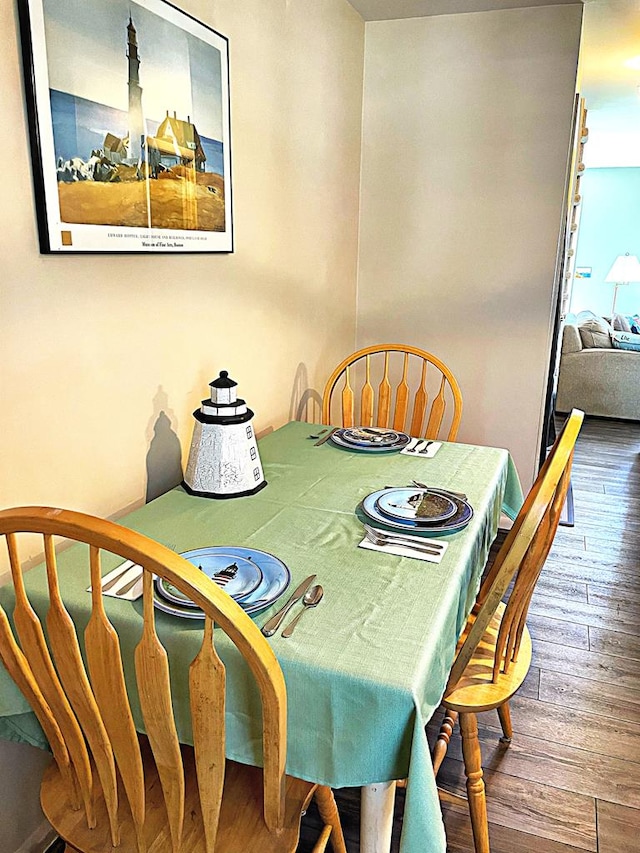 dining space with wood-type flooring