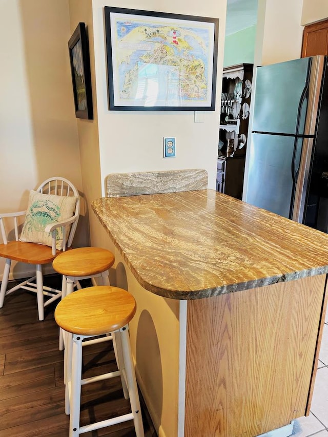 kitchen featuring a breakfast bar and light hardwood / wood-style flooring