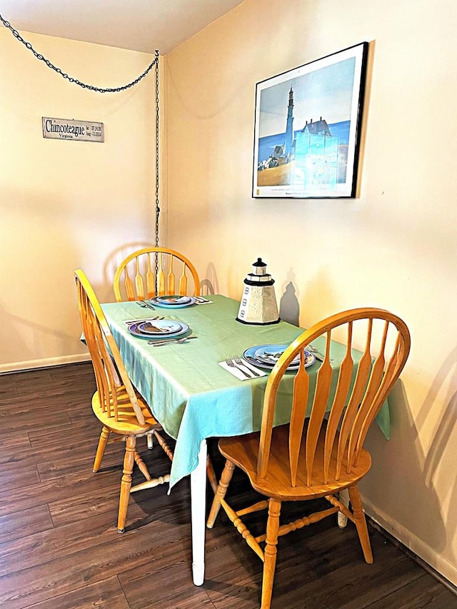 dining area with dark wood-type flooring