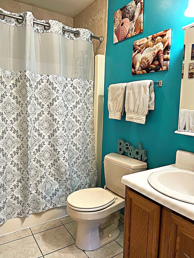 bathroom featuring tile patterned flooring, vanity, toilet, and a shower with shower curtain