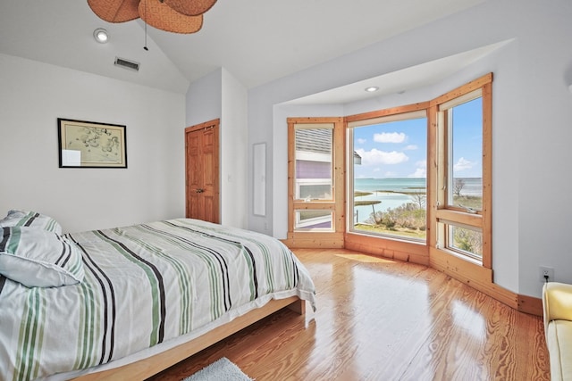 5095 Blake Point Rd, Chincoteague, VA 23336 - bedroom with a water view, wood finished floors, lofted ceiling, and recessed lighting