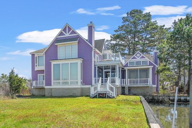 5095 Blake Point Rd, Chincoteague, VA 23336 - rear view of house featuring a chimney, a balcony, a lawn, crawl space, and stairway