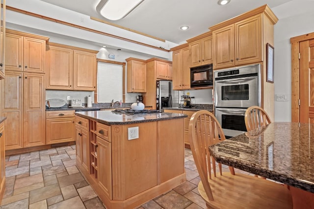 5095 Blake Point Rd, Chincoteague, VA 23336 - kitchen with appliances with stainless steel finishes, stone tile floors, a kitchen island, dark stone counters, and recessed lighting