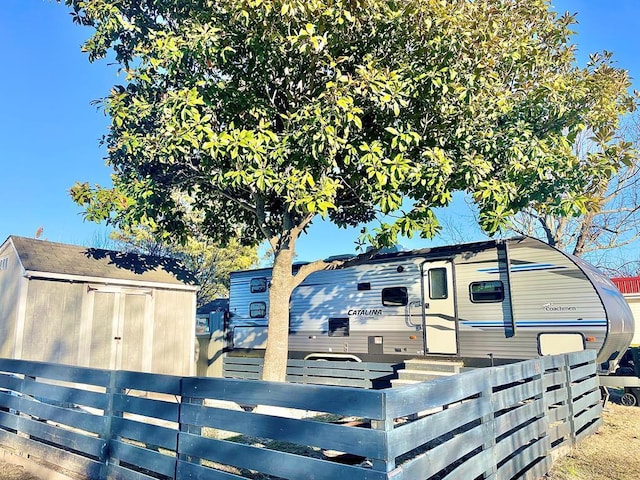 exterior space with an outbuilding and fence