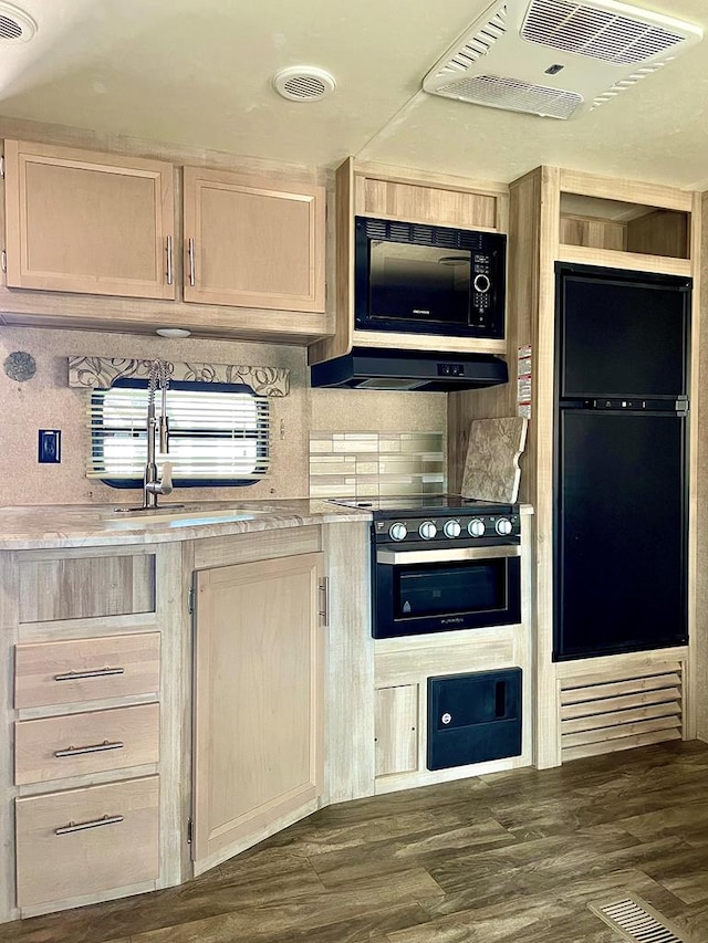 kitchen featuring black appliances, visible vents, and light countertops